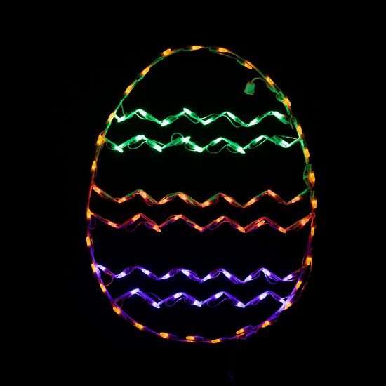 lit multicolored chevron striped lighted egg on black background