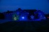 Front of home at night, lit by blue lights including C9 bulb Glitzer product
