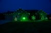Front of home at night, lit by green lights including C9 bulb Glitzer product