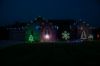 Front of home at night, lit by multi-color lights including C9 bulb Glitzer product