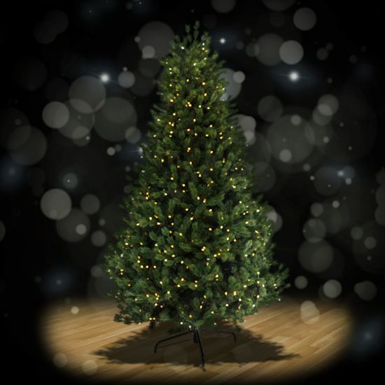 Full Swiss Pine 7.5 foot artificial Christmas tree, spotlit and lighted on black background with wooden floor.