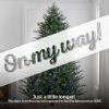 10' Full Fraser Pine displayed in lifestyle shot of living room, lit multi-color, graphic banner across the image with text saying "On my way!". Caption under banner says "Just a little longer! This item is on the way and expected to land by late summer 2025."