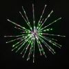 Christmas themed (pure white, green, and red) Spritzer displayed lit on a black background