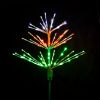 Paramount Spritzer yard stake decoration illuminated in pure white, red, and green against a black background.