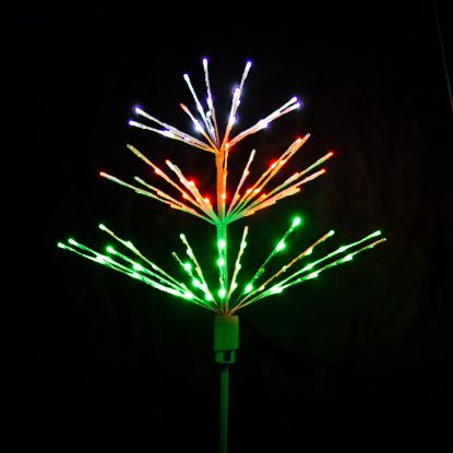 Paramount Spritzer yard stake decoration illuminated in pure white, red, and green against a black background.