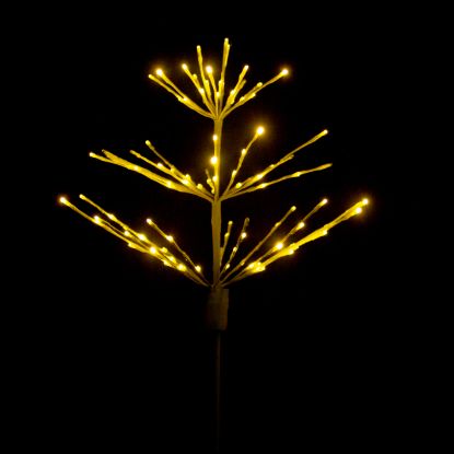 Paramount Spritzer yard stake decoration illuminated in warm white against a black background.