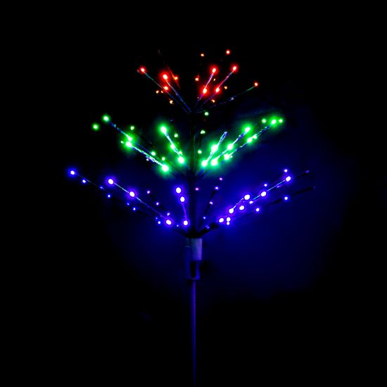 Paramount Spritzer yard stake decoration illuminated Halloween themed in orange, green, and purple against a black background.