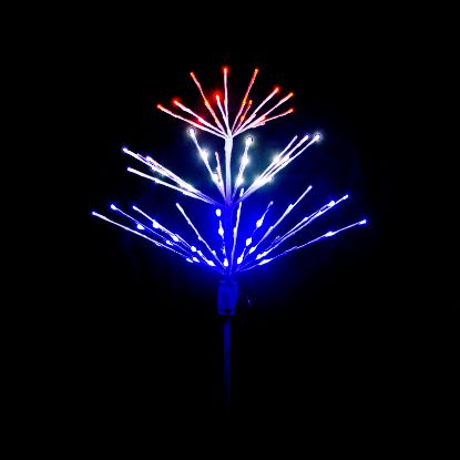 Paramount Spritzer yard stake decoration illuminated Patriotic themed in red, white and blue against a black background.
