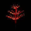 Paramount Spritzer yard stake decoration illuminated in blue against a black background.