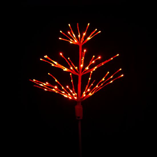 Paramount Spritzer yard stake decoration illuminated in blue against a black background.