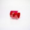 A small, plastic cellphone holder with a red interior and clear exterior, featuring the Holidynamics logo on the front. The holder is shaped like a curved “C” and sits on a white background.