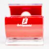 A small, plastic cellphone holder with a red interior and clear exterior, featuring the Holidynamics logo on the front. The holder is shaped like a curved “C” and sits on a white background.