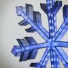 Close up of Lantern Snowflake displayed lit on off white background