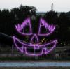 Lady Pumpkin Face Jack-O-Lantern lit in purple colors at Skinny Bones Pumpkin patch