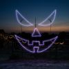 Sinister Pumpkin Face Jack-O-Lantern lit in purple colors at Skinny Bones Pumpkin patch