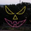 Sinister Pumpkin Face Jack-O-Lantern lit in multiple colors at Skinny Bones Pumpkin patch