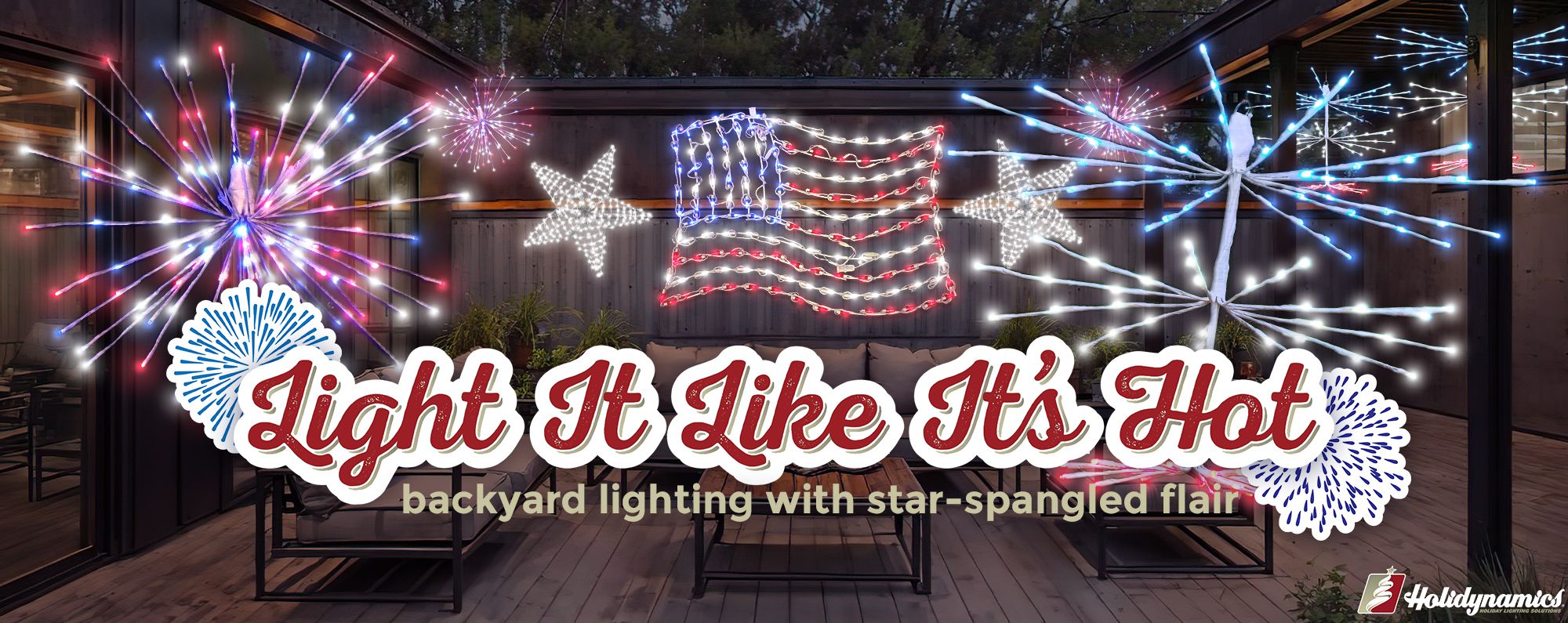 Backyard patio with large lit American flag metal frame lighting, two large metal frame stars lit white, large patriotic Paramount Spritzer and large 16" patriotic Spritzer with text saying "light it like it's hot" and "backyard lighting with star-spangled flair"